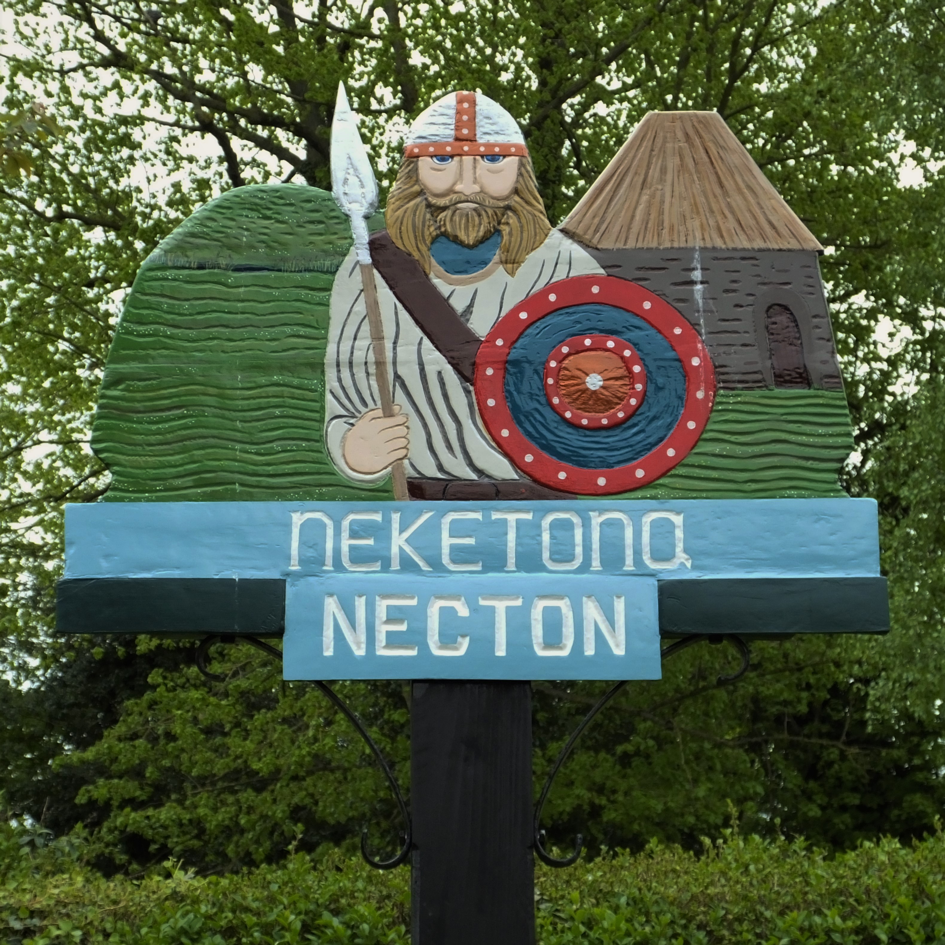 A picture
                  containing text, tree, outdoor, sign Description
                  automatically generated