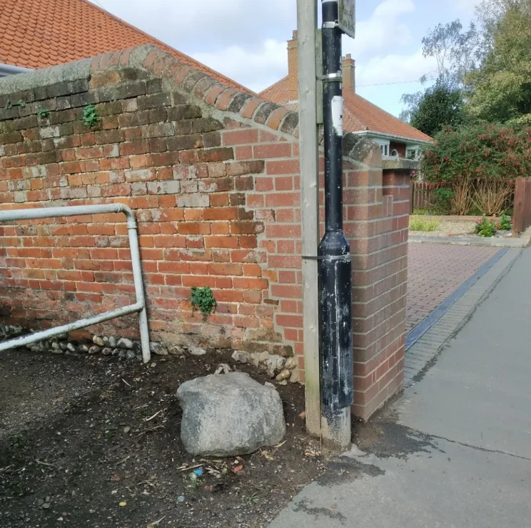 The Sarsen Stone at the entrance to the footpath opposite the Parish Church car park, Martham